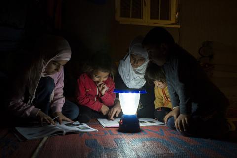 Children study by solar light in Jordan
