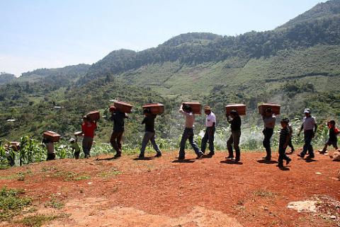 Ixil people carrying carry remains after an exhumation in the Ixil Triangle in February 2012