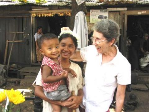 Maryknoll Sister Mary Grenough with a mother and child in Myanmar