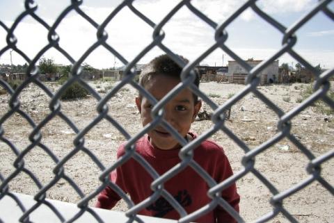 Boy behind border fence El Paso Texas