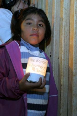 Child at prayer vigil at US-Mexico border wall