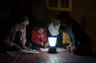 Children study by solar light in Jordan