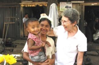 Maryknoll Sister Mary Grenough with a mother and child in Myanmar