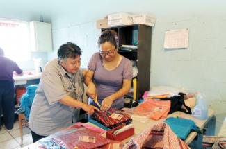 Maryknoll Sister Margaret Sierra, left, with member of a sewing cooperative in Juarez, Mexico, 2018.