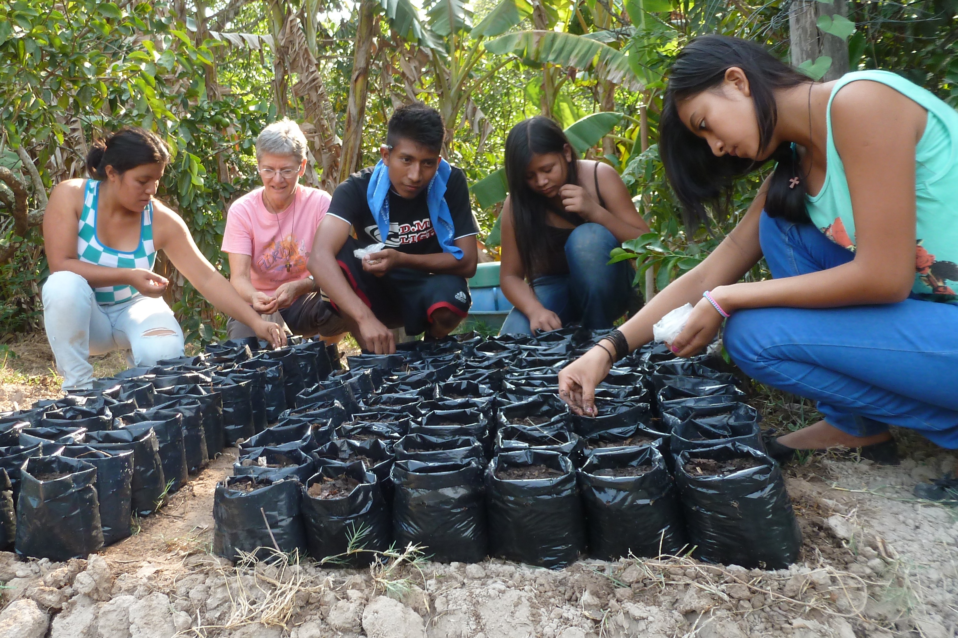 Roselia, Peg, Evaristo, Leti's sister & Leti planting seeds of rare tree