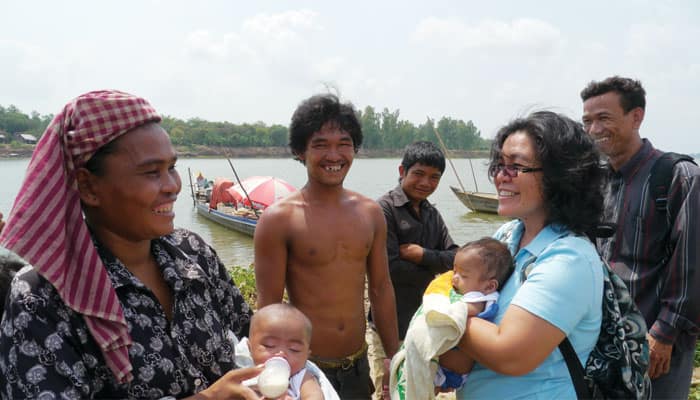 maryknoll_sister_leonor_montiel_holds_a_baby_of_a_family_in_cambodia
